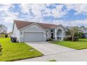 Charming single-story home with a well-manicured lawn, two-car garage, and inviting front entrance at 4119 Maidu Ct, St Cloud, FL 34772