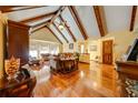 Spacious living room featuring vaulted ceilings, exposed beams, and gleaming hardwood floors at 4318 Oak Ct, St Cloud, FL 34769