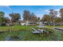 Waterfront backyard featuring a boat dock, boat lift, and mature trees on a large lot at 4815 Cypress Dr, Lake Wales, FL 33898