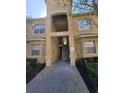 Condo building entrance with stairway to upper units at 501 Terrace Ridge Cir # 501, Davenport, FL 33896