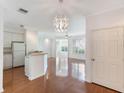 Living area featuring hardwood floors, bright lighting, white walls, and a modern light fixture at 5025 Wellington Park Cir # 68, Orlando, FL 32839