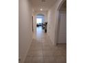 Bright hallway showcasing tiled floors and arched doorways, offering a glimpse into the home's living spaces at 5295 Timberland Ave, St Cloud, FL 34771