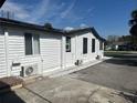 The side of the home features white siding, lots of windows and air conditioning units at 610 Illinois Ave, St Cloud, FL 34769