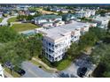 An aerial perspective shows this condominium in a community complete with landscaped lawns at 7503 Mourning Dove Cir # 301, Reunion, FL 34747