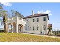 Charming exterior featuring a stucco facade, arched windows, and a classic Mediterranean tile roof at 802 S 10Th St, Haines City, FL 33844