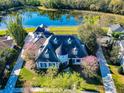 Stunning aerial view of property featuring a private lake and lush landscaping at 885 Spring Park Loop, Celebration, FL 34747