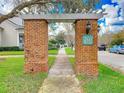 Spring Park Reserve brick entrance with pergola leading to sidewalk lined with trees at 885 Spring Park Loop, Celebration, FL 34747