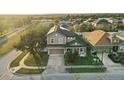 Aerial view of a two-story home with a well-kept lawn, landscaping and community at 1894 Valley Forge Dr, St Cloud, FL 34769