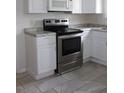 A kitchen featuring stainless steel appliances, white cabinets, and granite countertops at 1013 Illinois Ave, St Cloud, FL 34769