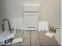 Selection of finish samples, including a cabinet door, flooring, and countertop at 1123 Olivine Ave, Dundee, FL 33838