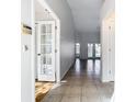 Bright hallway featuring tile flooring, leading to spacious rooms with ample natural light and open doorways at 12622 Earnest Ave, Orlando, FL 32837