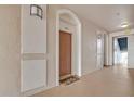 Well-lit hallway with a door numbered 302 and leading to additional doorways with an exit sign at 1357 Venezia Ct # 302, Davenport, FL 33896