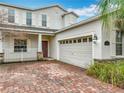 Charming two-story home with brick driveway, attached garage and covered porch at 15147 Driftwood Bend St, Winter Garden, FL 34787