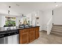 Open kitchen layout with a breakfast bar, connecting to the living area and offering easy access to the staircase at 2634 Corvette Ln, Kissimmee, FL 34746