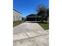 Charming one-story home with a dark garage door, a brick paver driveway, and neat lawn at 2638 Eagle Canyon N Dr, Kissimmee, FL 34746