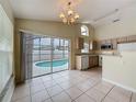 Bright kitchen with tile floors and sliding glass doors providing access to the pool area at 2993 Kokomo Loop, Haines City, FL 33844