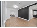 Elegant dining area with hardwood floors, dark accent wall, and stylish decor at 403 Poinciana Cir, Kissimmee, FL 34744