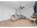 Bright living room with hardwood floors, white walls, and a comfortable sectional sofa at 403 Poinciana Cir, Kissimmee, FL 34744