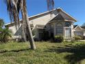 View of the side of the home showing the bay window and the lawn at 414 Otter Creek Dr, Kissimmee, FL 34743