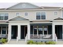 Attractive townhome exterior featuring a welcoming porch, adding charm and curb appeal at 452 Diamond Dove Cv, Winter Springs, FL 32708