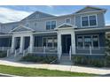 Well-maintained townhomes showcase inviting front porches, classic columns, and lush landscaping at 452 Diamond Dove Cv, Winter Springs, FL 32708