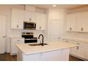 Modern kitchen featuring white cabinets, stainless steel appliances, and a quartz island at 452 Diamond Dove Cv, Winter Springs, FL 32708