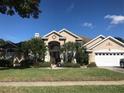 Inviting single-story home with lush landscaping, well-manicured lawn, and a charming front entrance at 4807 Wingrove Blvd, Orlando, FL 32819