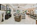 Spacious living room featuring decorative ceilings, neutral tones, tile flooring, and open concept design at 538 Via Vitale Ct, Kissimmee, FL 34759