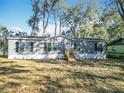 Charming single-story home featuring a gray exterior, black shutters, and a well-maintained front yard at 6189 Nw 68Th St, Ocala, FL 34482