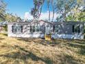 Charming single-story home featuring a gray exterior, black shutters, and a well-maintained front yard at 6189 Nw 68Th St, Ocala, FL 34482