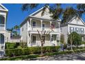 Charming two-story home featuring double porches, manicured landscaping, and classic architectural details at 826 Lake Evalyn Dr, Celebration, FL 34747