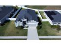 Aerial view of a well-maintained home with a dark roof and green lawn at 870 Galloway St, Lake Alfred, FL 33850