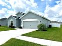 Beautiful one-story home with a well-kept lawn, an attached garage and a white driveway at 870 Galloway St, Lake Alfred, FL 33850