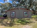 Exterior daytime view of a house with a red trim window and house number above at 888 Berkley Rd, Auburndale, FL 33823