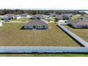 Expansive backyard enclosed by a pristine white fence offers ample space for recreation and outdoor activities at 1116 Caloosa Ridge Way, Babson Park, FL 33827