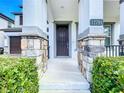 Inviting front entrance features stone pillars, manicured shrubs, and clear address numbers at 12791 Westside Village Loop, Windermere, FL 34786