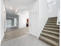 Bright foyer with tiled flooring, staircase, and views into living spaces at 12971 Westside Village Loop, Windermere, FL 34786