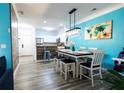 Bright dining area boasts modern lighting, stylish accents, and an open layout leading to the kitchen at 1351 Tuscan Ter # 8408, Davenport, FL 33896