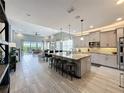Open concept kitchen with a large island, stainless steel appliances, and tiled floors at 16150 Parkwyn St, Winter Garden, FL 34787