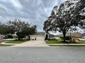 Inviting single-story home with mature trees, a three-car garage and lush landscaping at 168 Bradwick Cir, Debary, FL 32713
