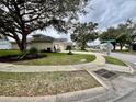 Quiet neighborhood street with mature trees and a sidewalk leading to landscaped yards at 168 Bradwick Cir, Debary, FL 32713