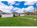 Charming home with a well-manicured lawn, stepping stone path, and a white picket fence at 2286 Sunny St, Kissimmee, FL 34741