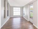 Bright living room featuring sleek wood floors, white trim, and abundant natural light at 2286 Sunny St, Kissimmee, FL 34741