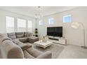Bright living room featuring a sectional sofa and modern decor at 2800 Cello Ln, Kissimmee, FL 34741