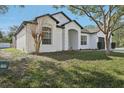 Stunning single-story home with lush green lawn, well manicured exterior, and a two-car garage at 411 Boxwood Dr, Davenport, FL 33837