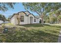 Well-maintained single-story home with lush front lawn and mature landscaping at 411 Boxwood Dr, Davenport, FL 33837