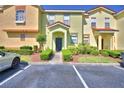 Inviting townhome with colorful exterior, manicured shrubs, and dedicated parking spaces at 500 Monroe Cir, Davenport, FL 33896