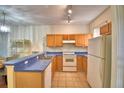 Functional kitchen with wood cabinets, modern appliances, and a breakfast bar at 500 Monroe Cir, Davenport, FL 33896