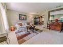 Cozy living room with a comfortable sofa, area rug, and view into the dining area at 6449 Eve St, St Cloud, FL 34771