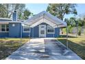 Covered parking area leading to the front entrance of a blue single-story home at 1006 San Domingo Rd, Orlando, FL 32808